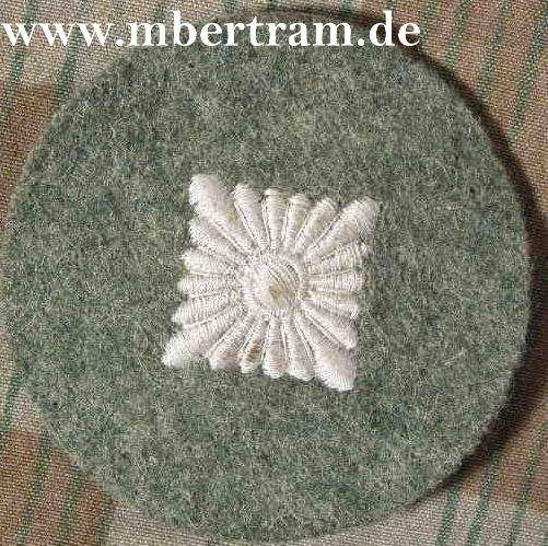 Ärmelabzeichen Oberschützenstern auf feldgrauem Tuch.